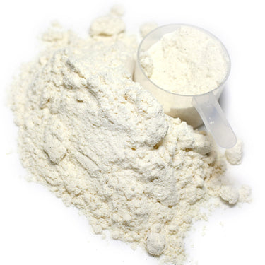 A clear scoop filled with white powder next to a mound of Clearly Fiber powder