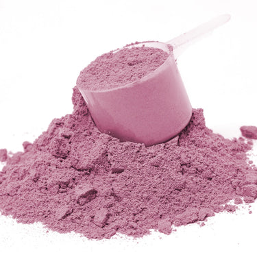 A plastic scoop filled with pink powder sitting on top of a mound of Spectra Purples™ powder