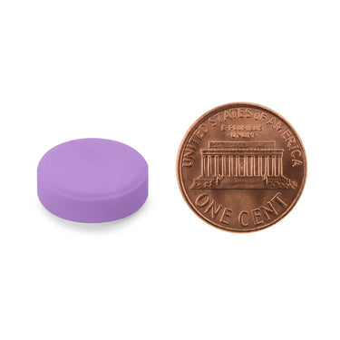 A purple tablet being compared to the size of a penny