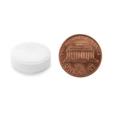 A white tablet being compared to the size of a penny